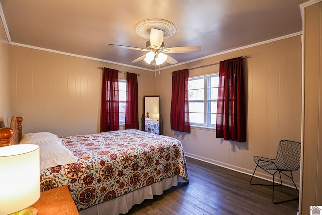 bedroom featuring ceiling fan, crown molding, dark wood-type flooring, and wooden walls