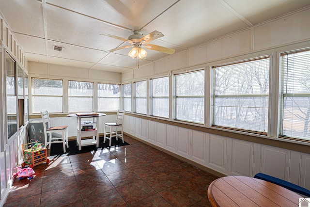 sunroom / solarium with plenty of natural light and ceiling fan