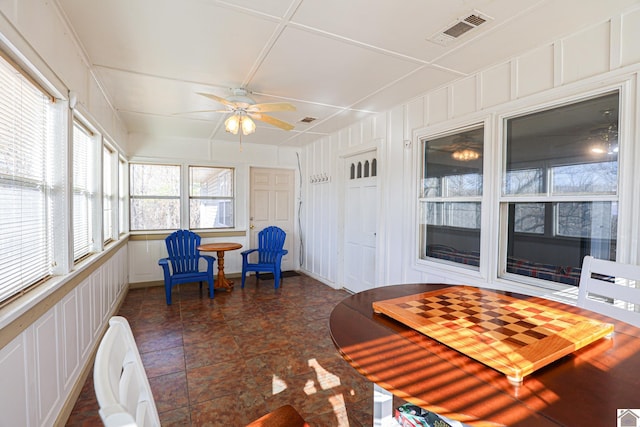 sunroom featuring ceiling fan