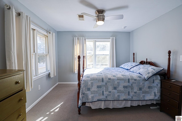 carpeted bedroom with multiple windows and ceiling fan