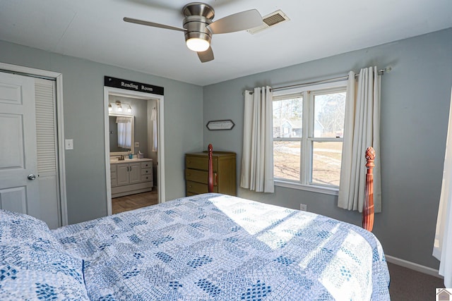 carpeted bedroom with connected bathroom, a closet, and ceiling fan