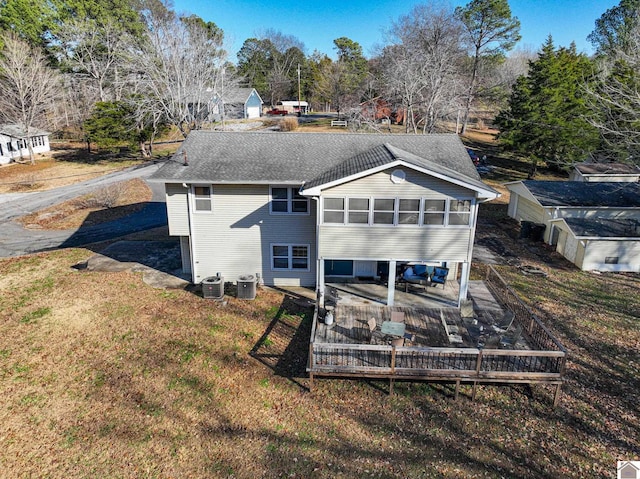 rear view of property with central AC and a sunroom