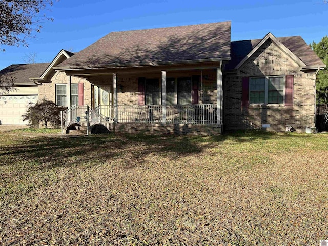 view of front of home with a porch, a garage, and a front lawn