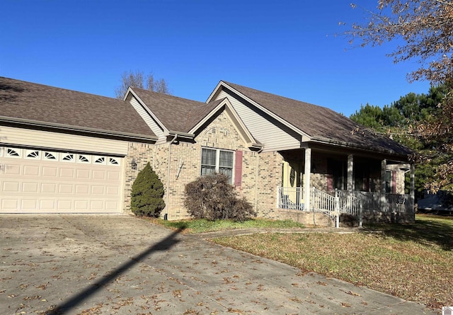 single story home with a porch and a garage