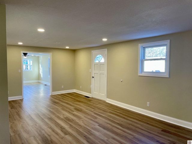 foyer featuring ceiling fan, plenty of natural light, and light wood-type flooring