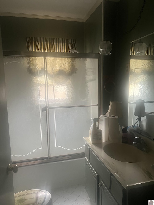 bathroom featuring vanity, tile patterned floors, and bath / shower combo with glass door