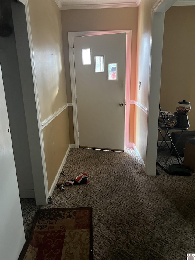 doorway to outside featuring crown molding and carpet