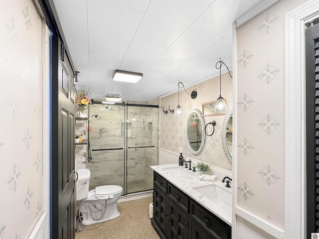 bathroom with toilet, an enclosed shower, and vanity