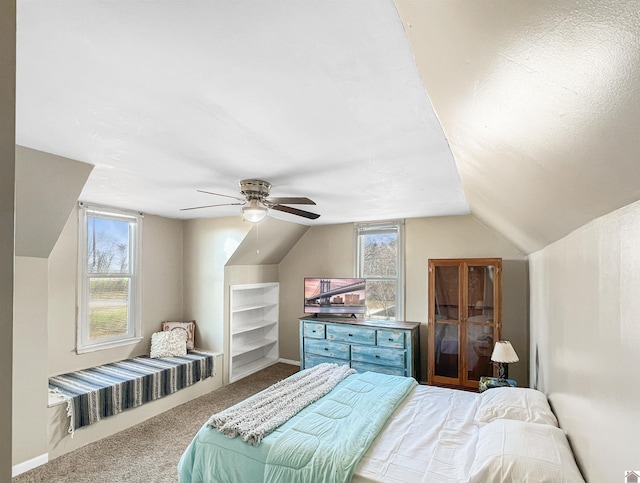 bedroom featuring ceiling fan, carpet floors, a textured ceiling, and lofted ceiling