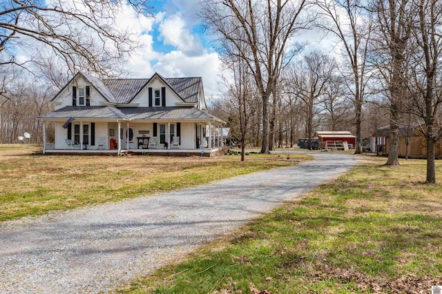 farmhouse-style home with a porch and a front lawn