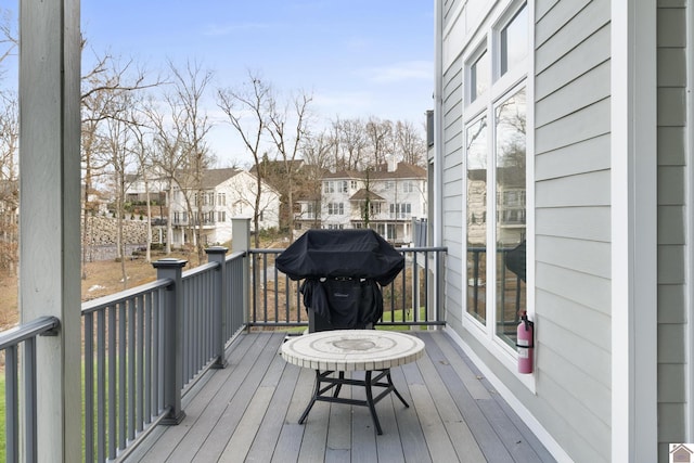 wooden deck with a grill