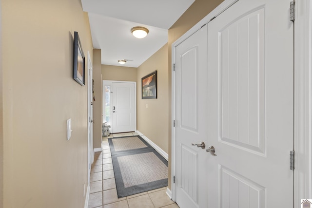 doorway to outside with light tile patterned floors