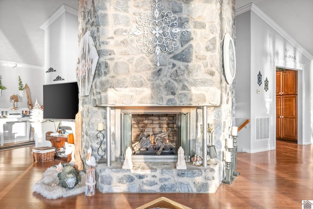 living room with a fireplace, wood-type flooring, and crown molding