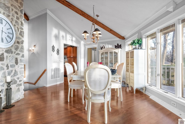 dining area featuring a notable chandelier, lofted ceiling with beams, dark hardwood / wood-style floors, and ornamental molding