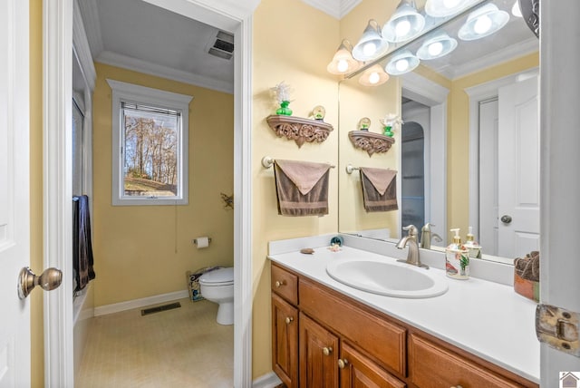 bathroom featuring vanity, toilet, and crown molding