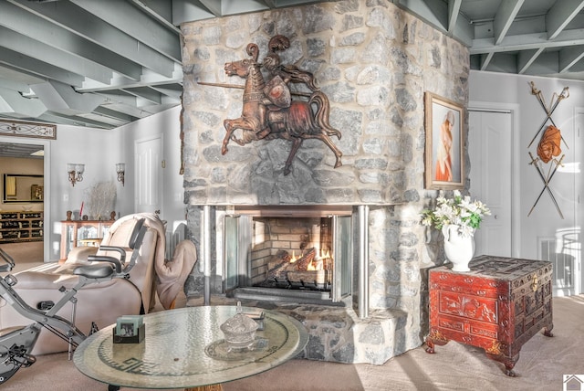 carpeted living room featuring a fireplace and beamed ceiling