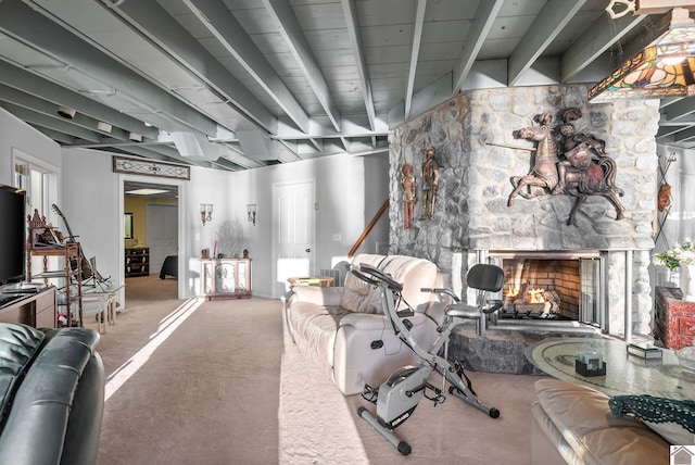 living room featuring carpet, a stone fireplace, and beamed ceiling