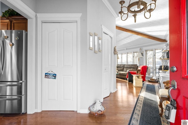 foyer featuring beamed ceiling, dark hardwood / wood-style flooring, and ornamental molding