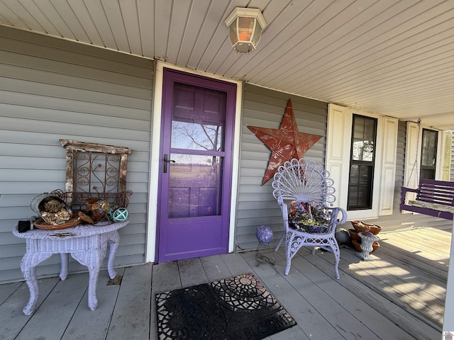 view of exterior entry with a porch