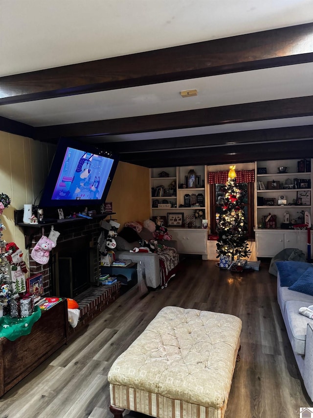 living room featuring beamed ceiling and hardwood / wood-style flooring