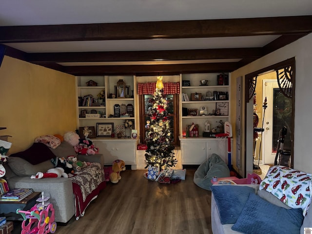 living room featuring hardwood / wood-style floors, built in shelves, and beamed ceiling