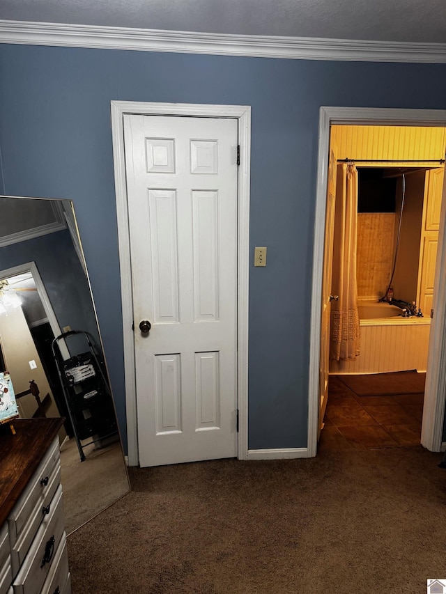 unfurnished bedroom featuring dark colored carpet and crown molding