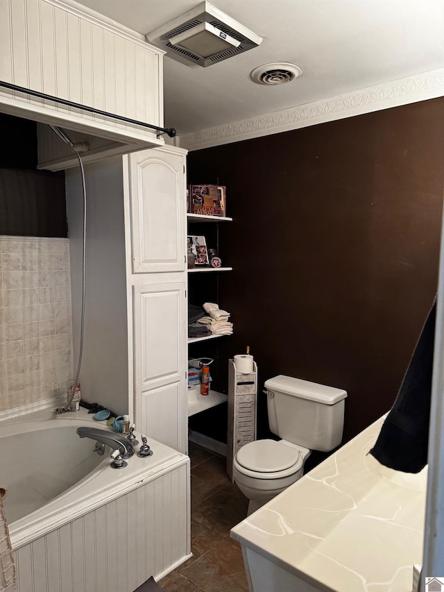 bathroom featuring tile patterned flooring, a bathtub, and toilet