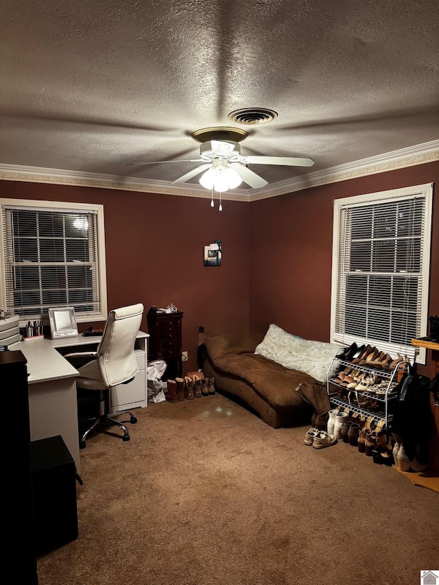 carpeted office featuring ceiling fan, a textured ceiling, and ornamental molding