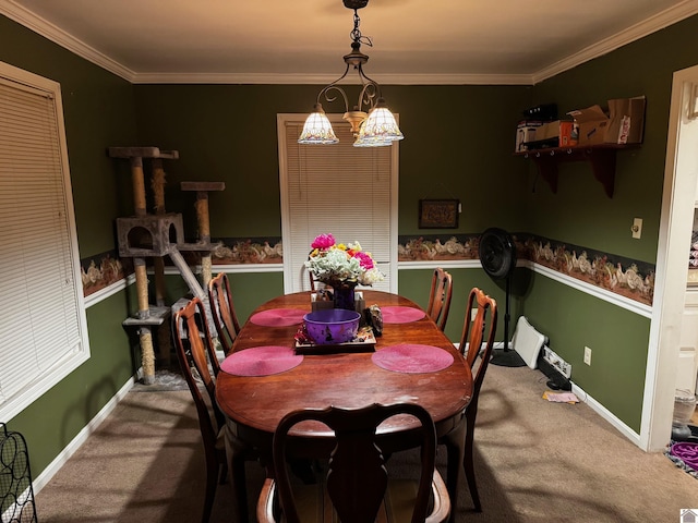 dining space with crown molding, carpet floors, and an inviting chandelier