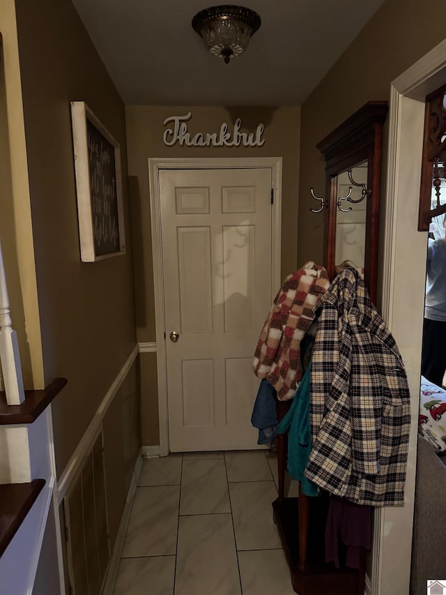 doorway with light tile patterned floors