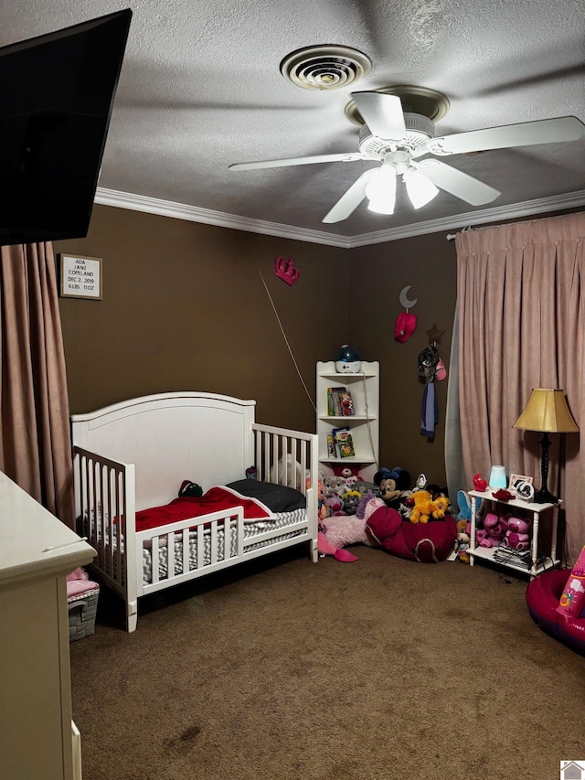 bedroom featuring a textured ceiling, a nursery area, dark carpet, and ceiling fan