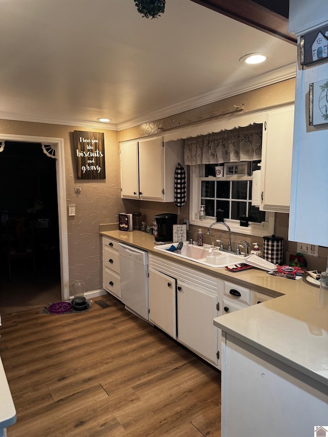 kitchen with white dishwasher, crown molding, dark wood-type flooring, sink, and white cabinets