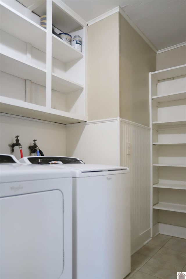 washroom with light tile patterned flooring, separate washer and dryer, and ornamental molding