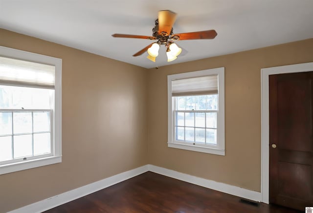 empty room featuring ceiling fan and dark wood-type flooring