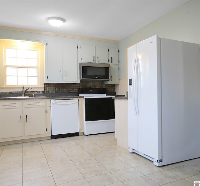 kitchen featuring white cabinetry, sink, tasteful backsplash, white appliances, and light tile patterned flooring