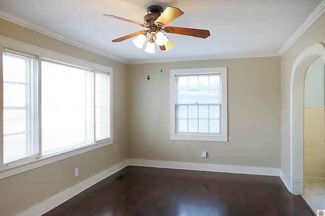 empty room featuring hardwood / wood-style flooring, ceiling fan, and ornamental molding