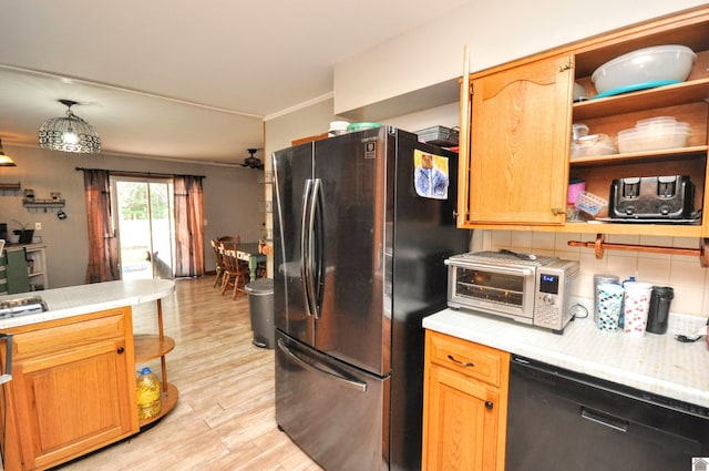 kitchen with black dishwasher, refrigerator, light hardwood / wood-style floors, and backsplash