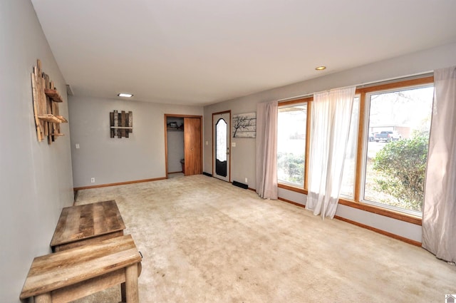 entrance foyer featuring light colored carpet