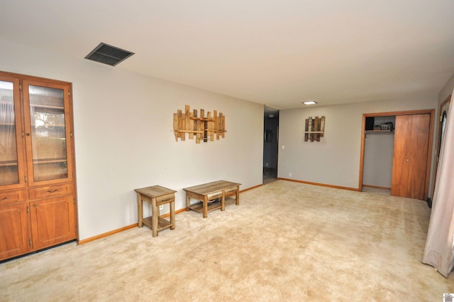 spare room featuring light colored carpet