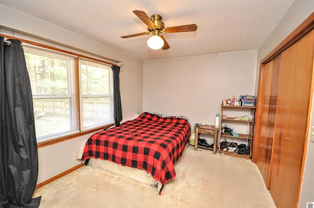 bedroom featuring light carpet, a closet, and ceiling fan