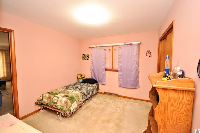 bedroom featuring light colored carpet