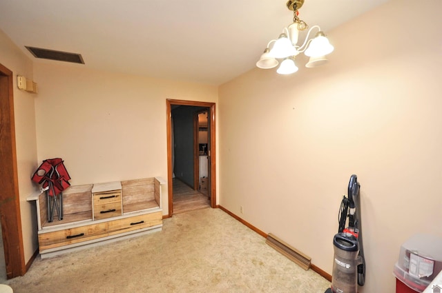 interior space with light colored carpet and an inviting chandelier