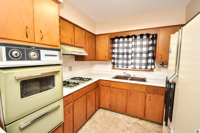 kitchen with decorative backsplash, white appliances, and sink