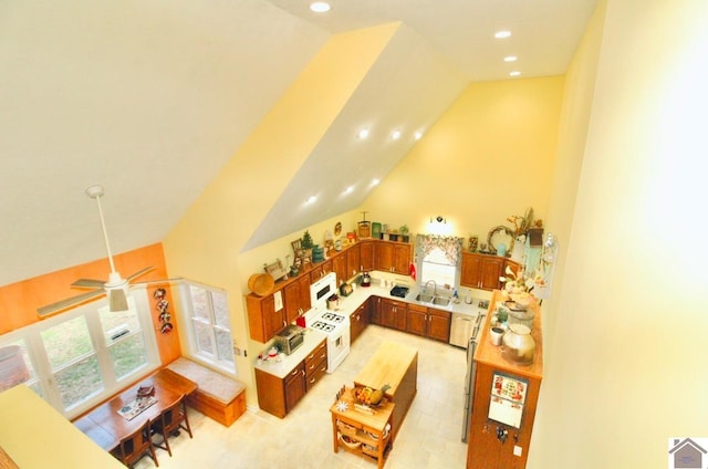 living room featuring ceiling fan, sink, and high vaulted ceiling