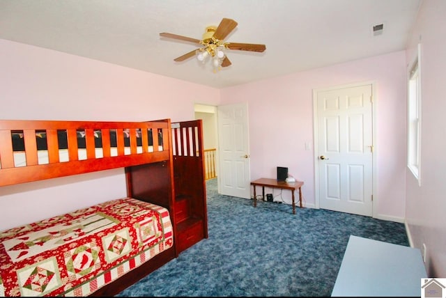 bedroom with dark colored carpet and ceiling fan