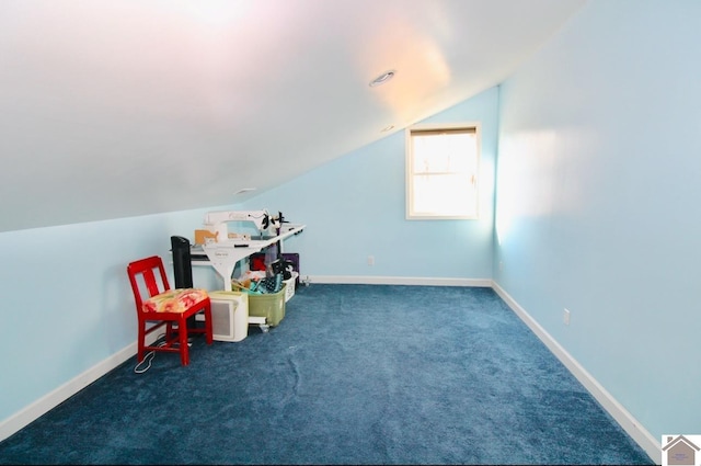 playroom featuring dark carpet and vaulted ceiling