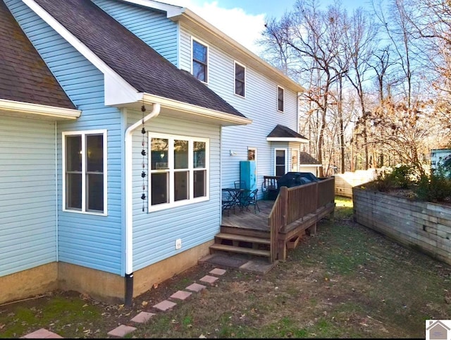 rear view of property featuring a deck