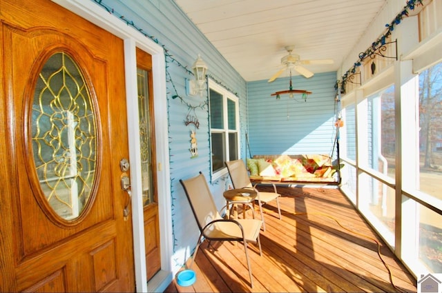 sunroom / solarium featuring ceiling fan