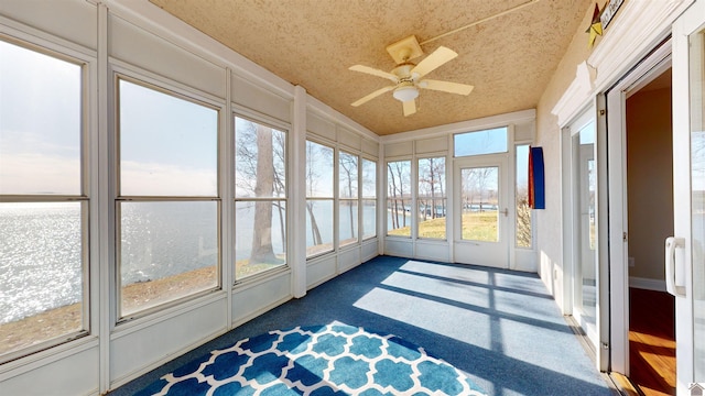 sunroom / solarium featuring plenty of natural light and ceiling fan