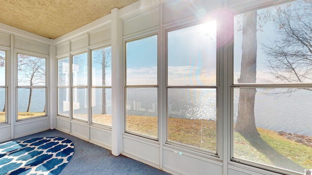 unfurnished sunroom with a water view and a wealth of natural light